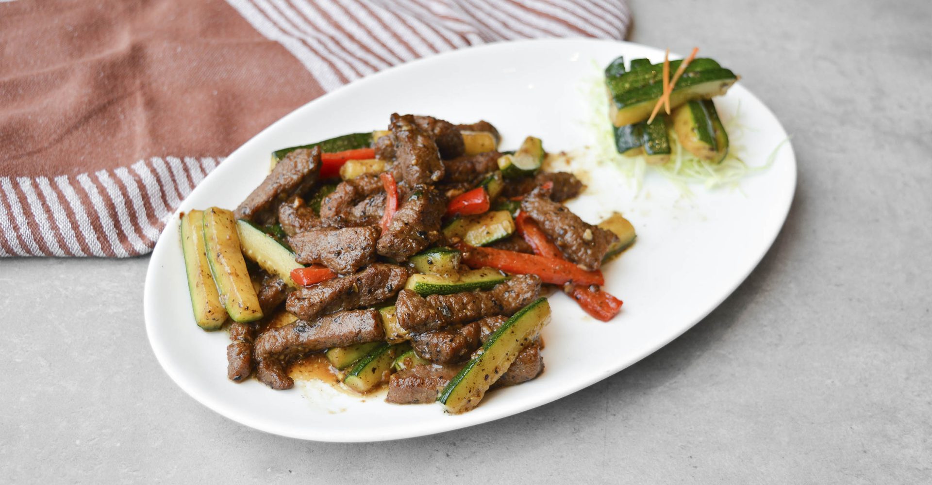 Wok-fried beef fillet with zuccini in truffle sauce